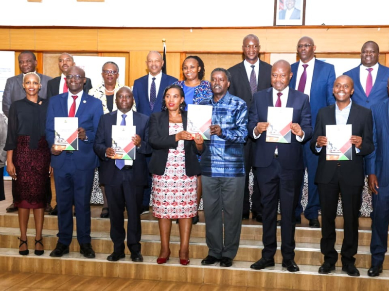 The CS, MICDE, Dr. Margaret Ndung’u (fifth left) accompanied by ICT and Digital Economy PS Eng. John Tanui (left), Sector Working Group (SWG) Chairperson Prof. Timothy Waema (right) and the PS for BT Prof. Edward Kisiang’ani during the handover ceremony of the ICT SWG Final Report at the KSG on 16th September, 2024.